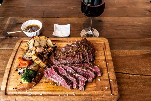 Argentine cut of meat called Vacio with chorizos and chimichurri.