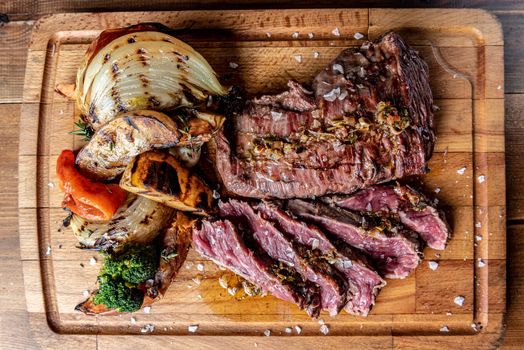 Argentine cut of meat called Vacio with chorizos and chimichurri.
