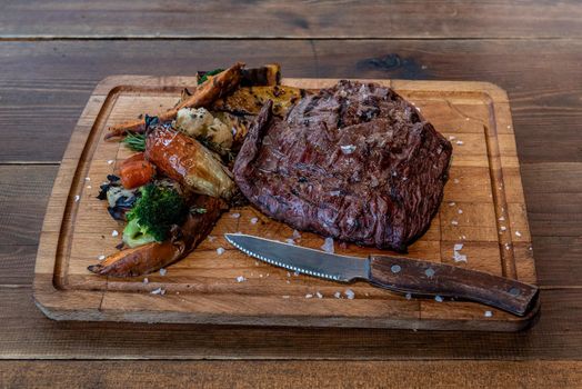 Argentine cut of meat called Vacio with chorizos and chimichurri.