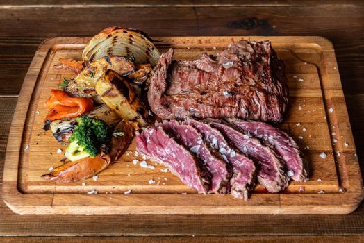 Argentine cut of meat called Vacio with chorizos and chimichurri.