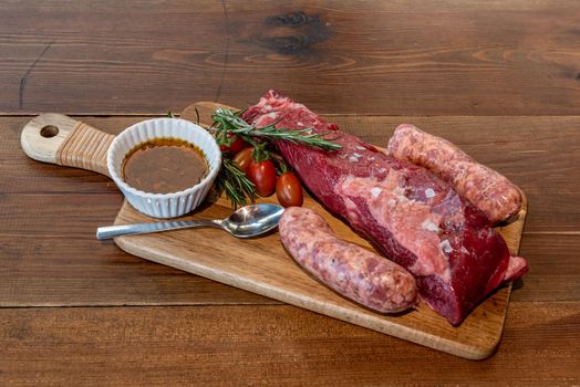 Argentine cut of meat called Vacio with chorizos and chimichurri.