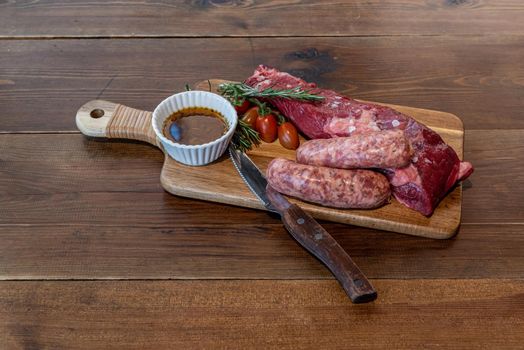 Argentine cut of meat called Vacio with chorizos and chimichurri.