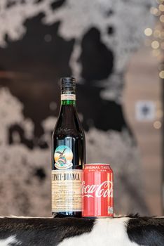 Andorra La Vella, Andorra: 2021 February 25: Typical Argentine drink, Fernet Braca with Coca Cola on cowhide in winter 2021.