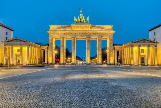 The famous illuminated Brandenburg Gate in Berlin at dawn
