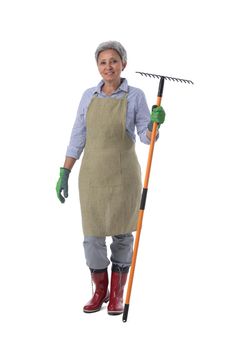 Gardening. Mature woman gardener worker with rake isolated on white background, full length portrait