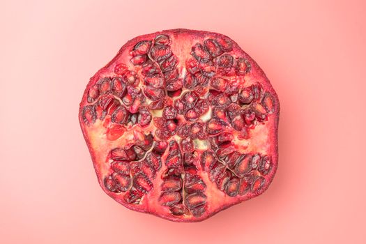 ripe pomegranate on a pink background. love. Fruit. High quality photo