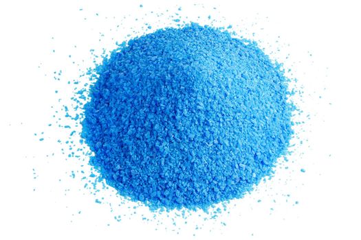 Pile of blue copper sulfate granules - close-up isolated on white background. Edge-to edge sharp.