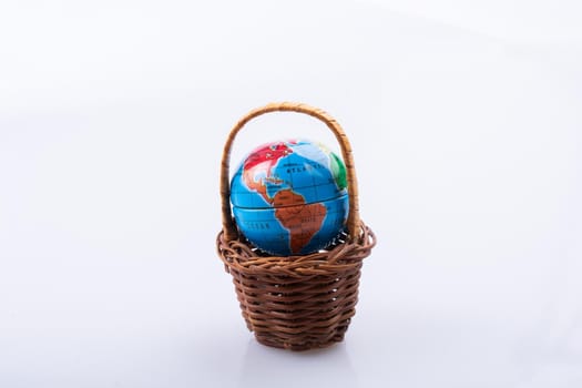 Little model globe in a basket in view