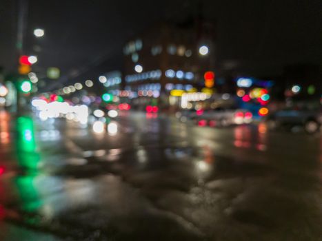 defocused night rain city street cross roads view.