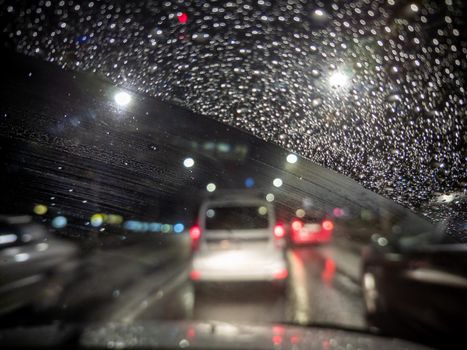 defocused photo of night driver view on city from right steering car - short sightness problem