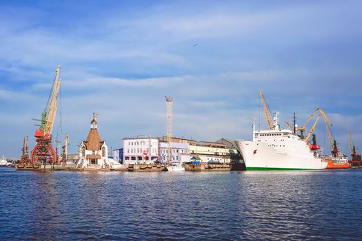 Kaliningrad , Russia. Port of a large Russian city with ships and various equipment on the background of the river.