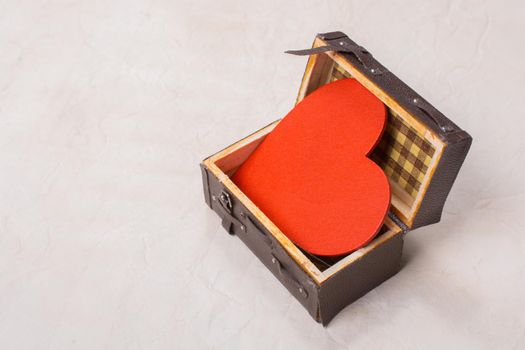 Heart shape icon in a suitcase as love and romance concept