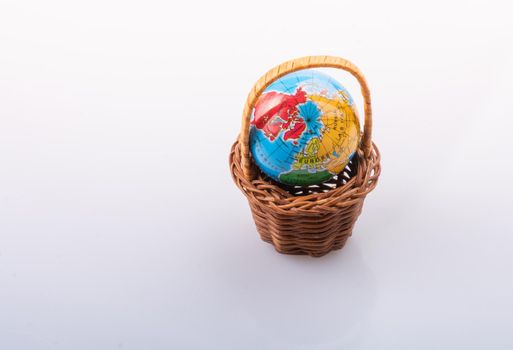 Little model globe in a basket in view