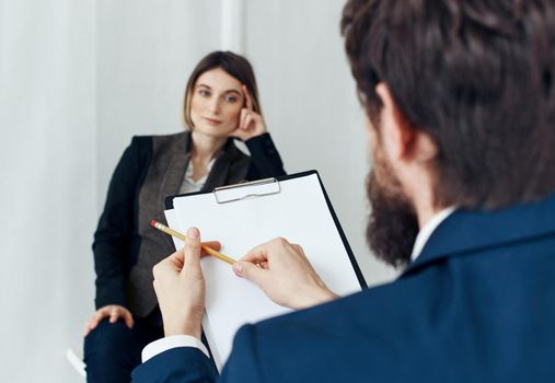 Woman for job interview and man with documents in the foreground. High quality photo
