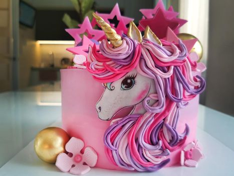 The concept of a festive dessert for children on their birthday in the form of a fantastic unicorn.Texture or background