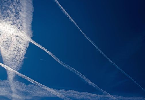 blue sky with many clouds lines made of aircraft.