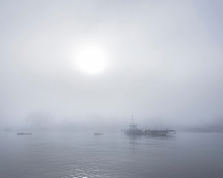 ferry in the mist on river lek near culemborg and utrecht in the netherlands