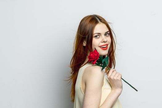 attractive woman with rose flower in hands emotions studio. High quality photo