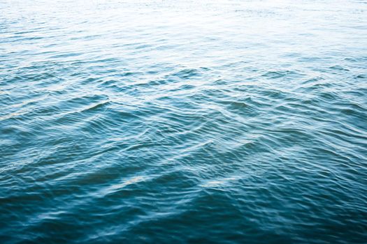 Rippled water surface background, gradient from dark blue to bright, water texture