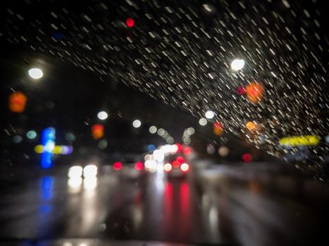 defocused photo of night driver view on city from right steering car - short sightness problem