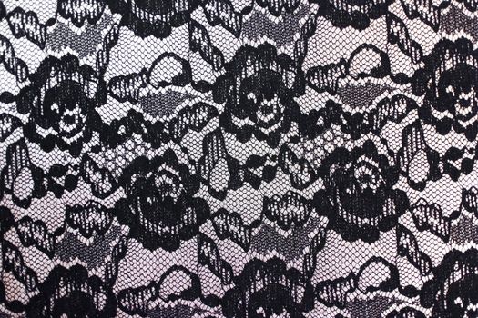Fabric texture background close-up. The texture of the black and white fabric with flowers of the textile upholstery of furniture. High quality photo