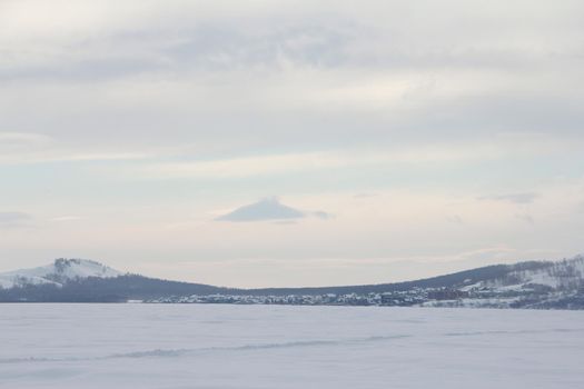 Beautiful winter landscape with Lake Bannoe and mountains in snow in South Ural, Russia