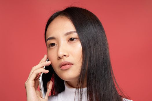 woman asian appearance studio cropped view talking on the phone. High quality photo