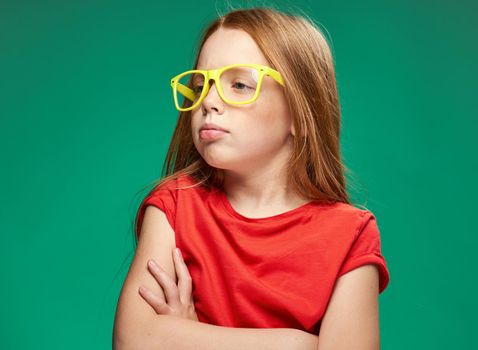 cute girl red hair glasses education school green background. High quality photo