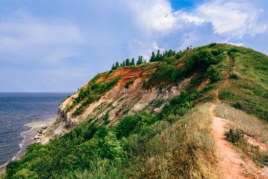 Hiking trail on mountainside at summer cloudy day