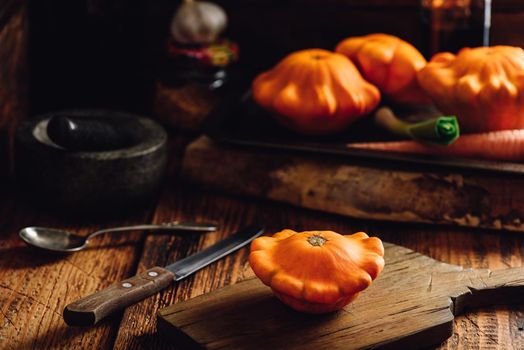 Yellow pattypan squash on cutting board