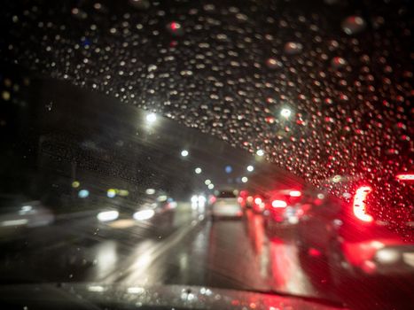 defocused photo of night driver view on city from right steering car - short sightness problem