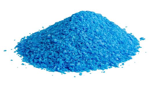 Pile of blue copper sulfate granules - close-up isolated on white background. Edge-to edge sharp.