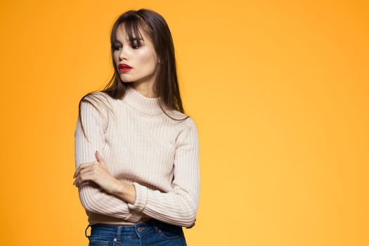 Cute brunette red lips fashionable clothes studio yellow background. High quality photo