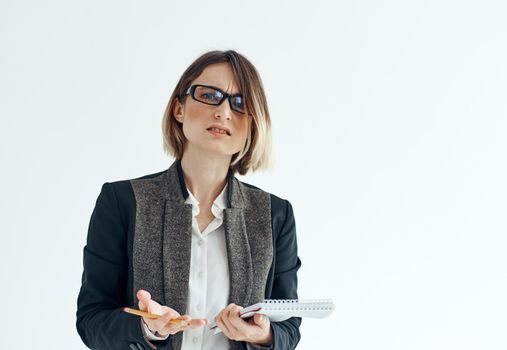 Cropped view of a business woman in a classic suit with documents on a light background. High quality photo