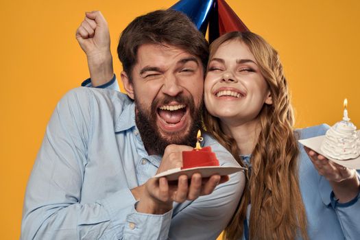 Birthday party man and woman fun yellow background cap holiday. High quality photo