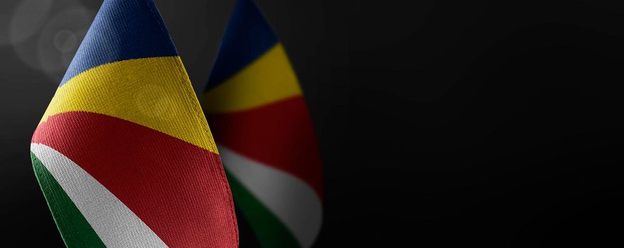 Small national flags of the Seychelles on a dark background.