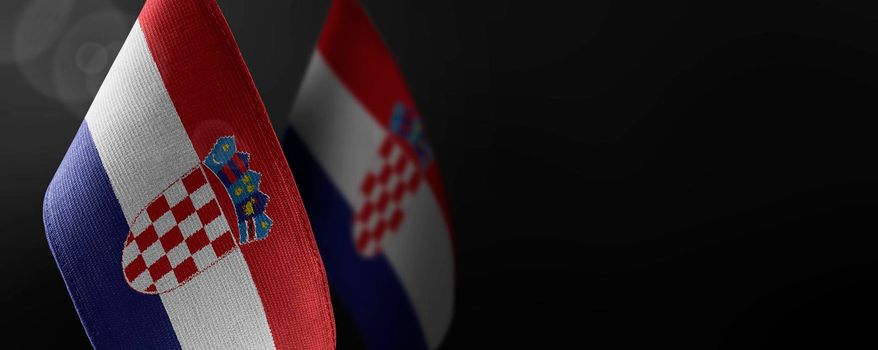 Small national flags of the Croatia on a dark background.