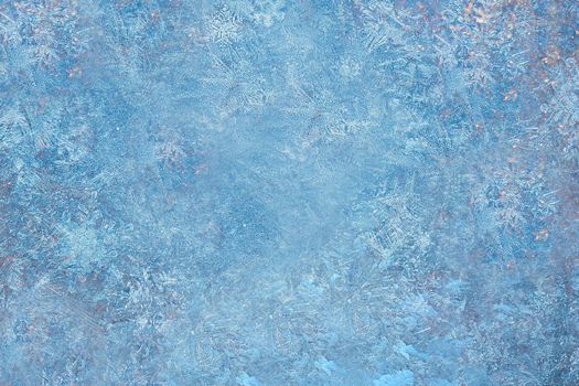 Blue background pattern made by frost on the window.Texture or background