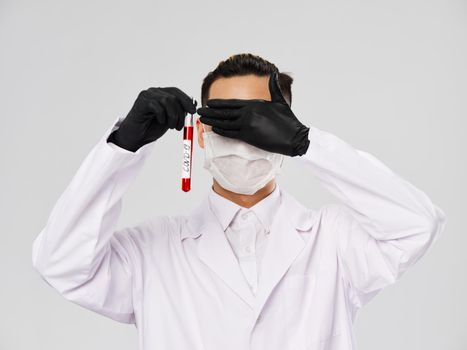 laboratory assistant closes eyes analyzes diagnostics research gray background. High quality photo