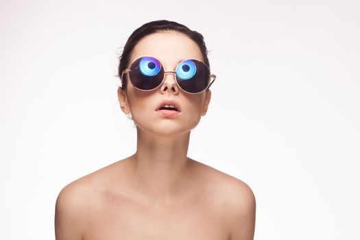 attractive woman naked shoulders sunglasses charm light background. High quality photo