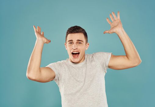 Handsome man in white t-shirt studio lifestyle blue background. High quality photo