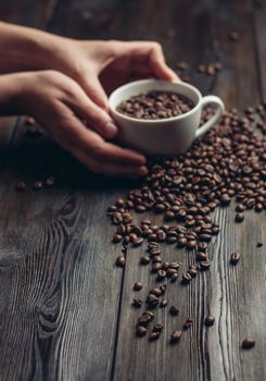 cup and saucer coffee beans on a wooden background aroma. High quality photo