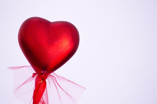 Shiny red heart on rainbow background. Copy space