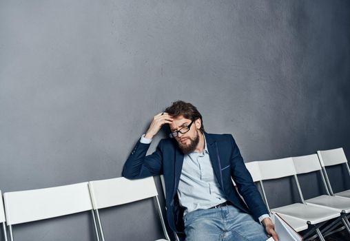 A man in a suit waiting for a job interview trying emotions. High quality photo