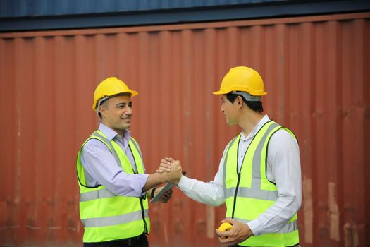 Logistics engineer control at the port, loading containers for trucks export and importing logistic concept