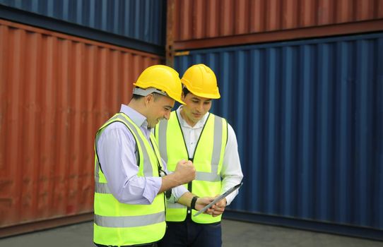 Logistics engineer control at the port, loading containers for trucks export and importing logistic concept