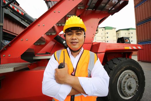 Foreman control loading Containers box from Cargo freight ship for import export. Container Warehouse Worker