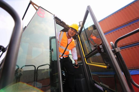 Foreman control loading Containers box from Cargo freight ship for import export. Container Warehouse Worker