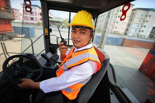 Foreman control loading Containers box from Cargo freight ship for import export. Container Warehouse Worker