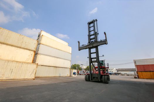 Engineer or supervisor checking and control loading Containers box from Cargo at harbor.Foreman control Industrial Container Cargo freight ship at industry.Transportation and logistic concept. 